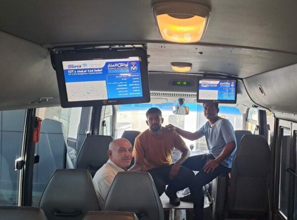 Nibras Al-Manar team inside a school bus after installing a telematic system 